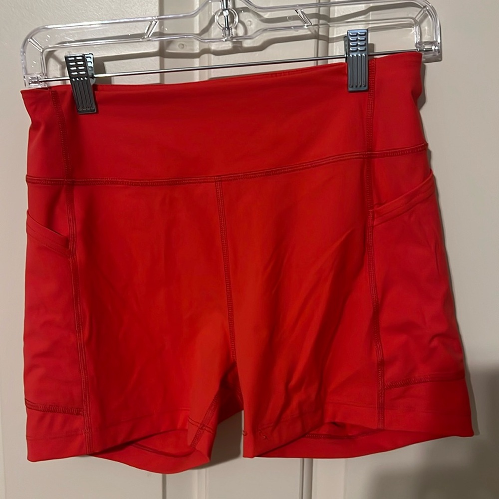 Outdoor Voices 4in inseam Lycra shorts: Red/orange color. Size Medium